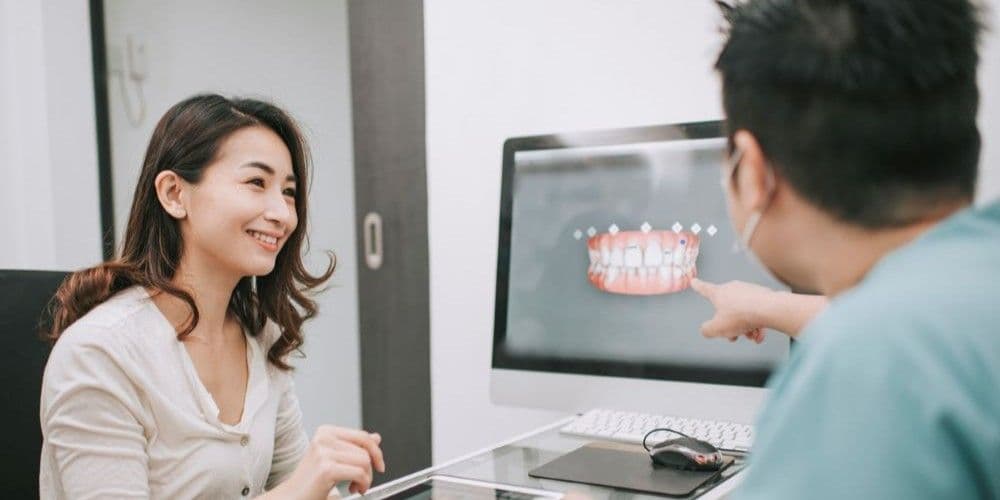 Dental patient speaking with her dentist.