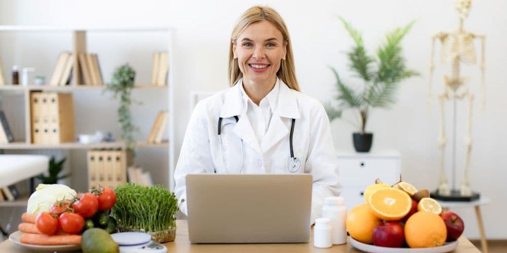 A Doctor at her desk, ready to help her patients learn more about how they can improve their health.