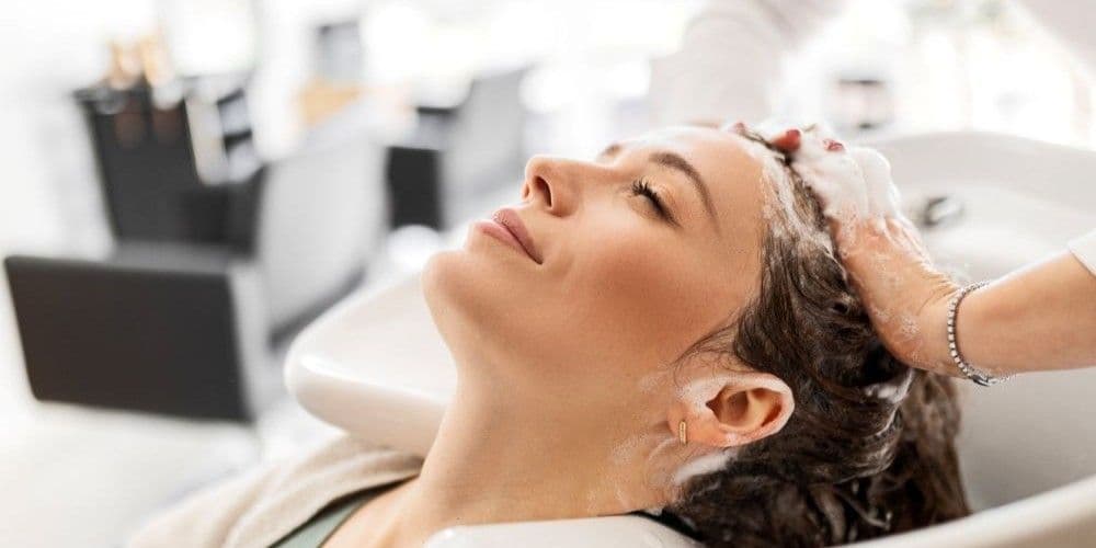 Woman getting her hair shampooed.